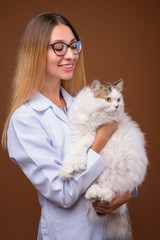 Portrait of veterinarian doctor woman holding Persian cat