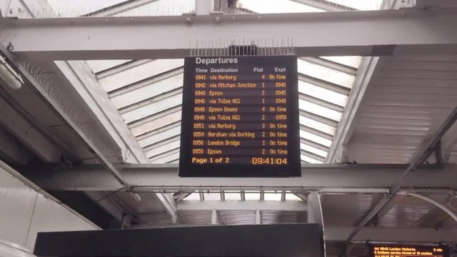 Departure board inside a London train station.
