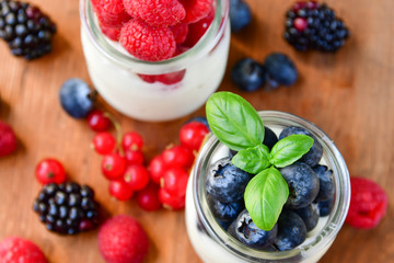  yogurt with raspberries, blackberries, currants, mint leaves. the concept of diet food and vitamins, Breakfast at the hotel. selective focus