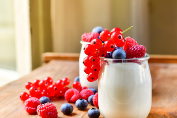  yogurt with raspberries, blackberries, currants, mint leaves. the concept of diet food and vitamins, Breakfast at the hotel. selective focus