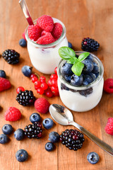  yogurt with raspberries, blackberries, currants, mint leaves. the concept of diet food and vitamins, Breakfast at the hotel. selective focus