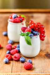  yogurt with raspberries, blackberries, currants, mint leaves. the concept of diet food and vitamins, Breakfast at the hotel. selective focus