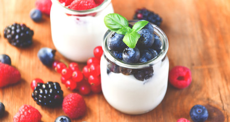 yogurt with raspberries, blackberries, currants, mint leaves. the concept of diet food and vitamins, Breakfast at the hotel. selective focus