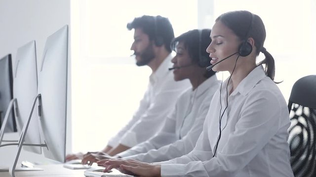 Call Center Agents Consulting Clients On Hotline At Office