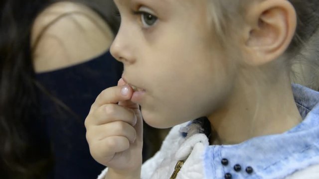 Little girl ats something