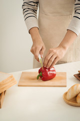 Male hands slicing fresh red bell peppers