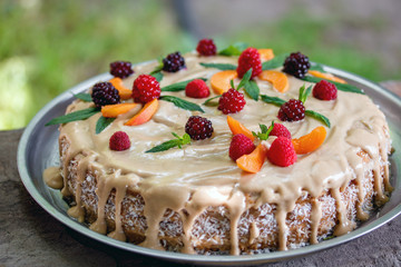vegan raw cake with berries peach, mint and cashew cream