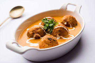 Malai Kofta Curry is a Mughlai special recipe served in a bowl. Selective focus