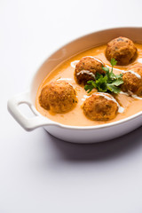 Malai Kofta Curry is a Mughlai special recipe served in a bowl. Selective focus