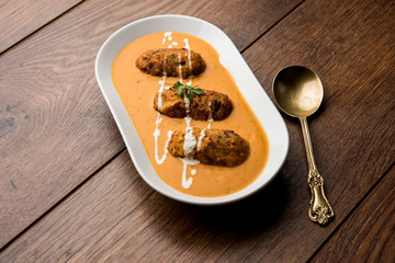 Malai Kofta Curry is a Mughlai special recipe served in a bowl. Selective focus