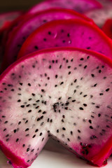 Slices of pink dragonfruit with white flesh 
