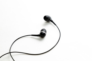 Black earphones on black background