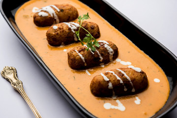 Malai Kofta Curry is a Mughlai special recipe served in a bowl. Selective focus