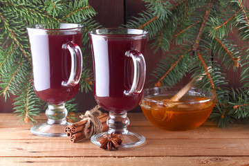 Mulled wine and Christmas tree branches on wooden boards. Christmas mulled wine, cinnamon sticks,...