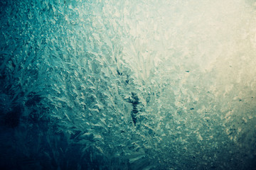 Frosty pattern on the glass, dark blue and yellow.