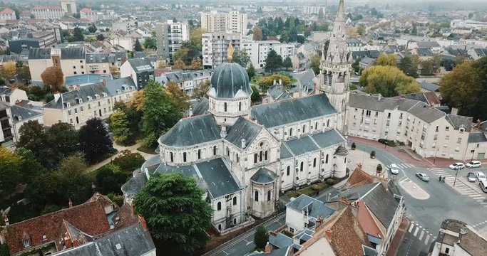 Aerial view of ancient Church Notre-Dame in French commune of Chateauroux on background with peculiar townscape