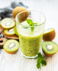Fototapeta na wymiar Glass of kiwi smoothie with fresh fruits