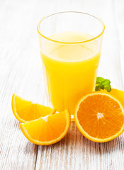 Glass of juice and orange fruits