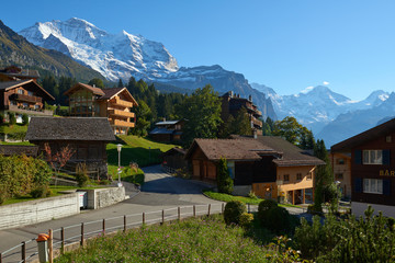 Fototapeta na wymiar Jungfrau mountain view from the street of Wengen village in Switzerland.
