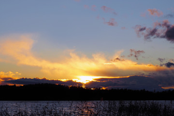 Sunset over the pond water. Wild calm nature of the North for recreation and fishing.
