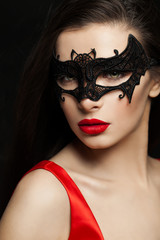 Sexy brunette woman in carnival mask, female face closeup