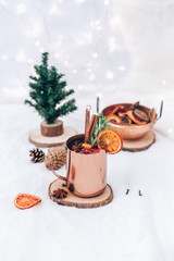 Mulled wine in mug with spices. Christmas hot drink on white background with copy space. Holiday concept