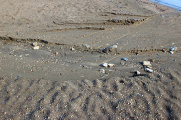 Fototapeta na wymiar Beach sand rain water drainage into sea