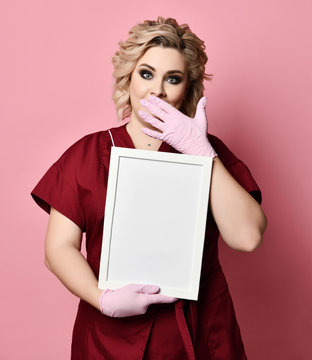 Young excited woman holding empty blank board surprised on pink