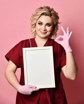 Young excited woman holding empty blank board smiling show ok sign on pink 