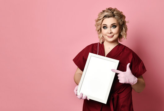 Young excited woman holding empty blank board smiling on pink
