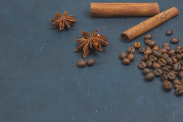 roasted coffee beans scattering in the corner of the background. beans on a dark background. view from above. copy space.
