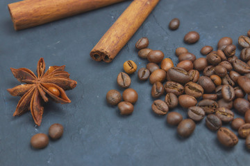 roasted coffee beans scattering in the corner of the background. beans on a dark background. view from above. copy space.
