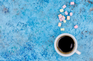 coffee drink with marshmallows and spices. on a dark background. view from above. copy space. morning refreshing drink.