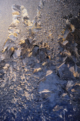 Frost and ice crystals on window glass. Winter background.