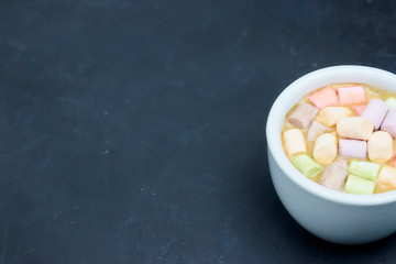 coffee drink with marshmallows and spices. on a dark background. view from above. copy space. morning refreshing drink.