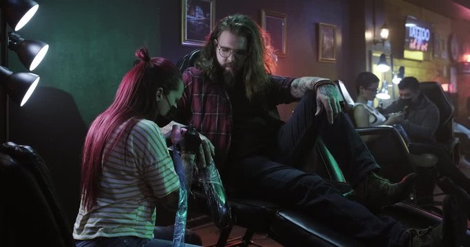 Slow Motion Portrait of a Biker Man Having Tattoo Done