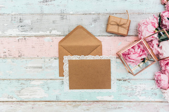 Mockup  greeting card and envelope with pink peonies on a vintage background