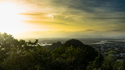 Fototapeta na wymiar Beautiful sunset in the Marble mountains in Da Nang ,charming view for the city,jungle and sea,travel concept.