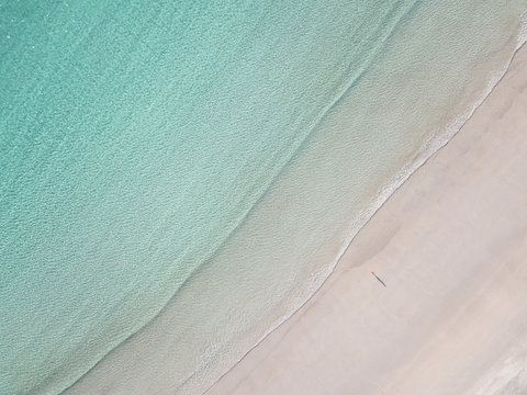 High angle view of lonely man on the Lofoten beach with copy space