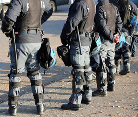 police in riot gear with flak jackets and protective helmets