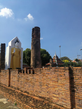 Standing Buddha Statue, Ancient buddhist Thai temple in Wat Pra sri rattana mahathat woramahavihan (Wat Yai) Phitsanulok, Thailand.