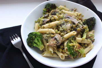 Pasta with Green vegetables: broccoli, mushrooms and peas. Vegan food. Top view and copy space.