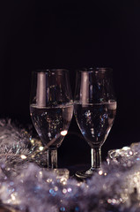  New Year. Glasses with champagne. New Year on the table are glasses of champagne and in the background is a beautiful bokeh. New year happy mood.