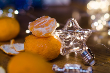 Fototapeta na wymiar Tangerines and beautiful lights and bokeh in the background .New year. Christmas card
