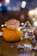 Tangerines and beautiful lights and bokeh in the background .New year. Christmas card