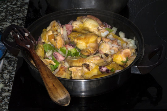 stew of meat, chicken with peas and squid