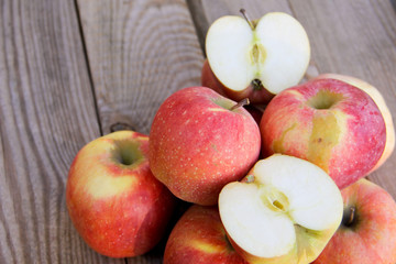 Fresh red apples on wooden table