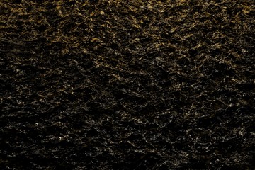 beautiful orange holiday sparkling water in the night with lights reflection - abstract background of electric lights reflected in black liquid