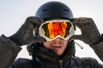 snowboarder in helmet and mask on top