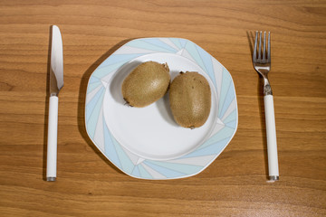 Kiwi fruit on a porcelain plate on a table